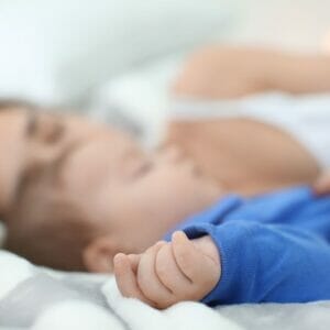 mom and baby asleep in bed