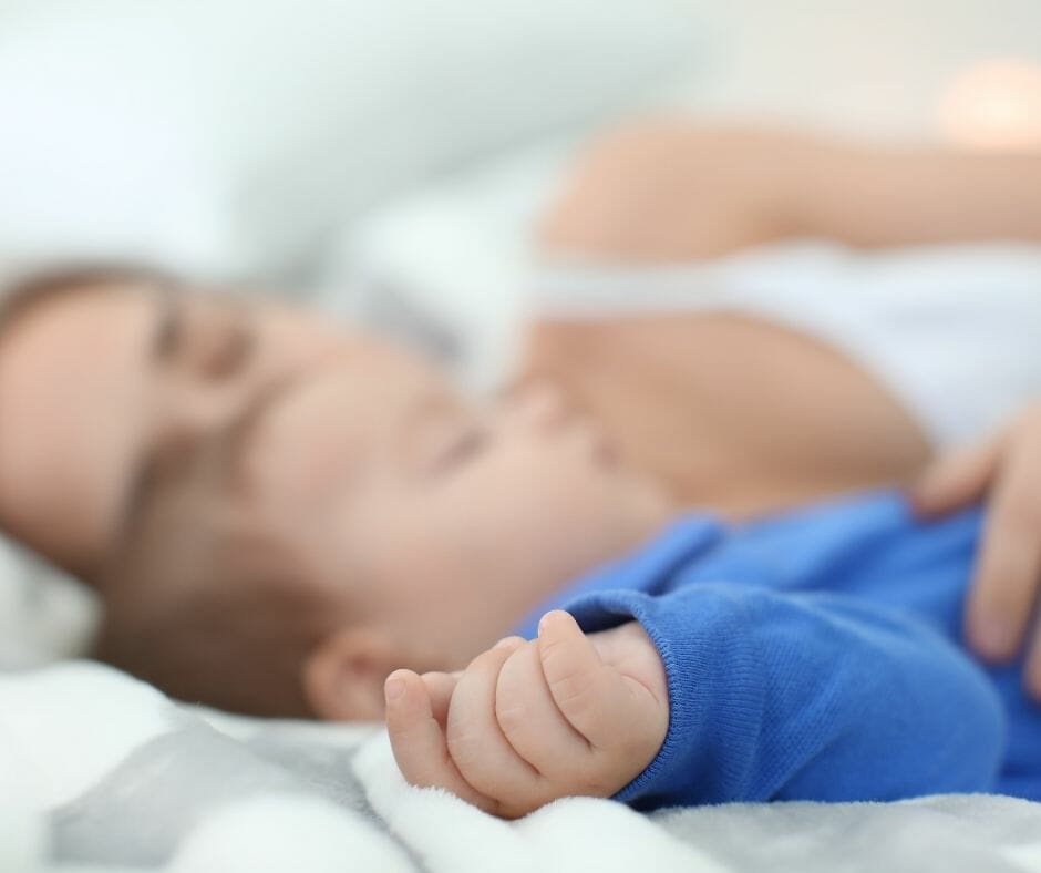 co-sleeping mom and baby asleep in bed