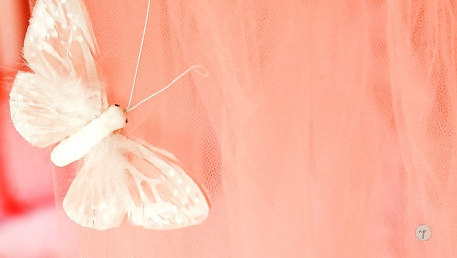 Close up of butterfly clipped to princess bed canopy