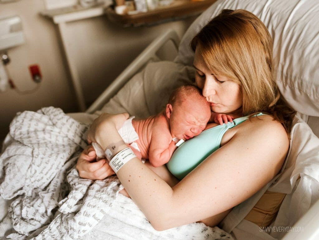 kissing newborn river after birth