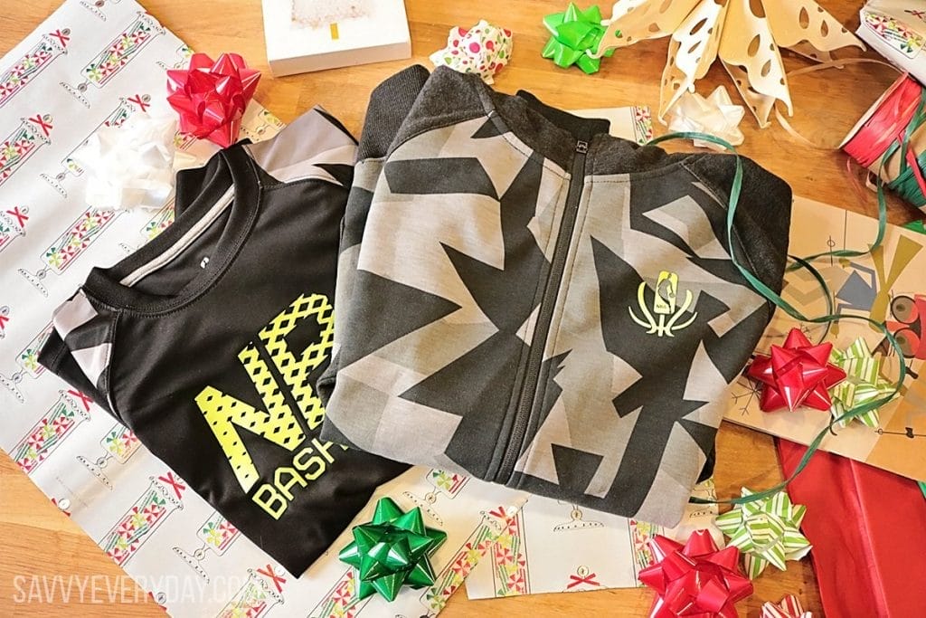 Photo of NBA Reflective jacket and shirt on a table with gift wrapping paper and bows