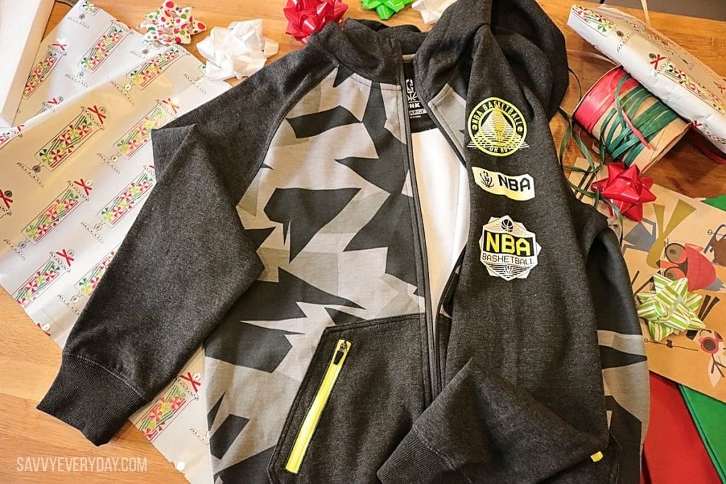 NBA Reflective Collection jacket set on top of gift wrap and bows