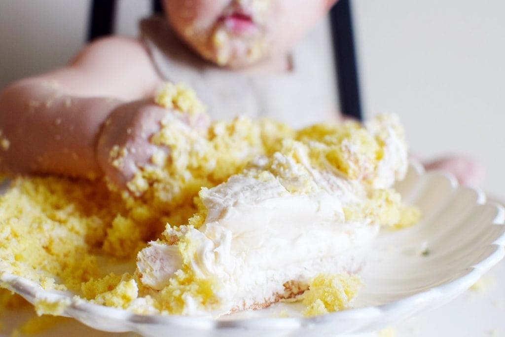 baby with a handful of cake