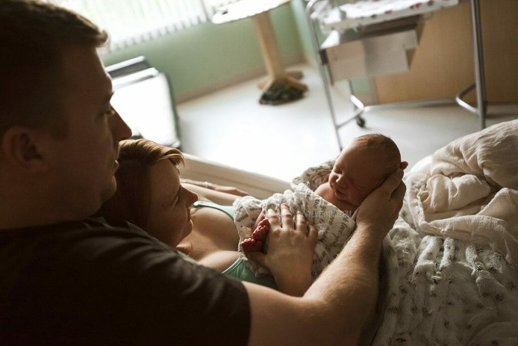 parents looking at baby