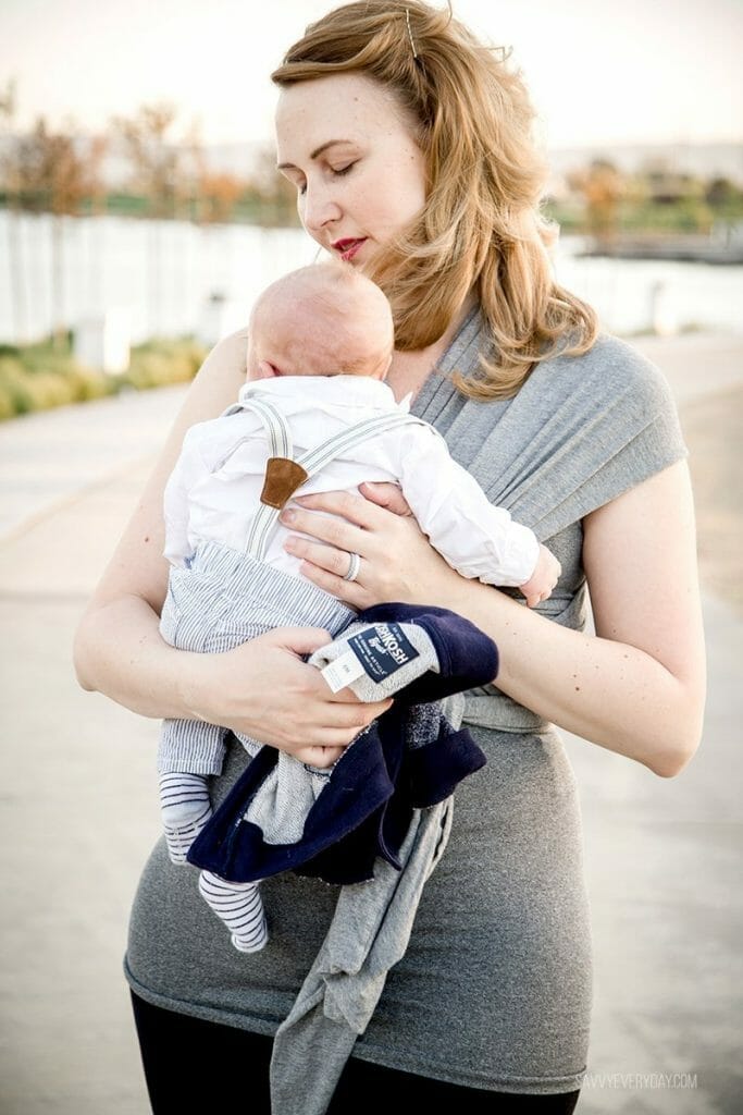 holding baby by the lake