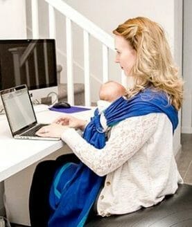 sitting on birthing ball at desk, researching things while babywearing