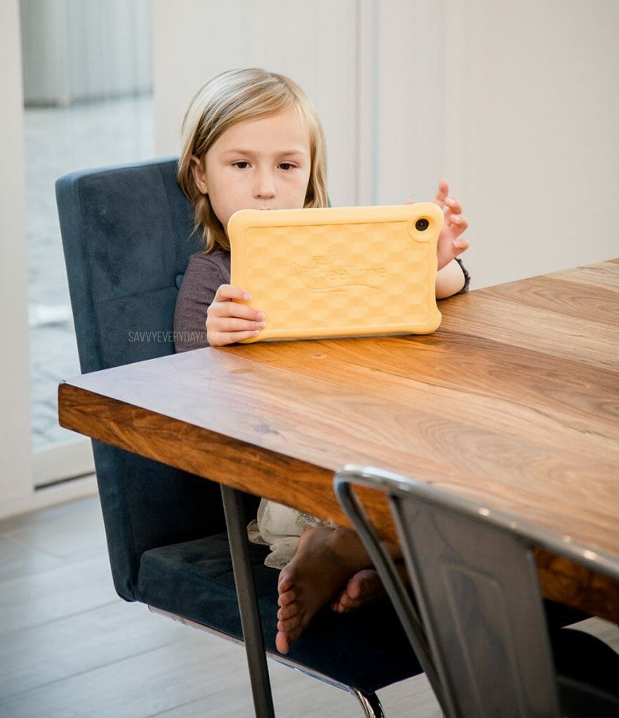 S sitting at the table with her Fire Kids Tablet