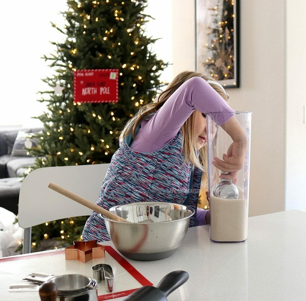 little girl scooping sugar - holiday traditions for young families