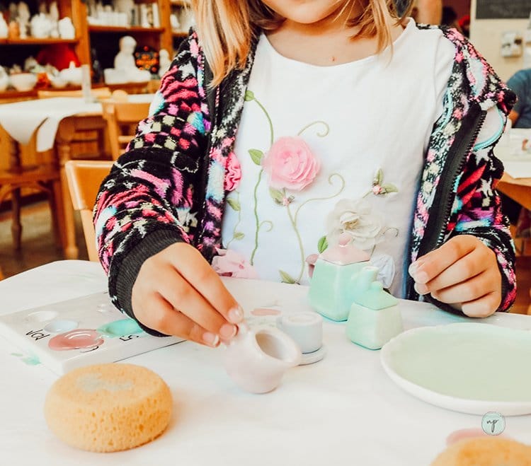 Savannah playing with her tea set after painting it