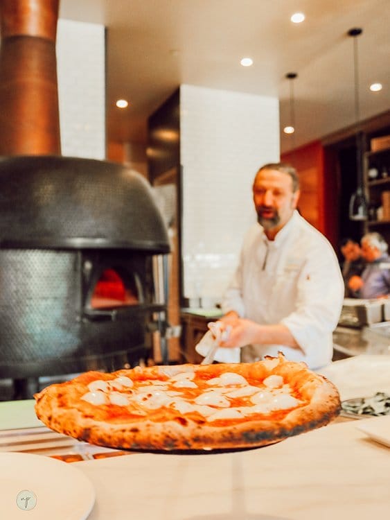 Trabocco owner Giuseppe Naccarelli shows pizza out of the fire