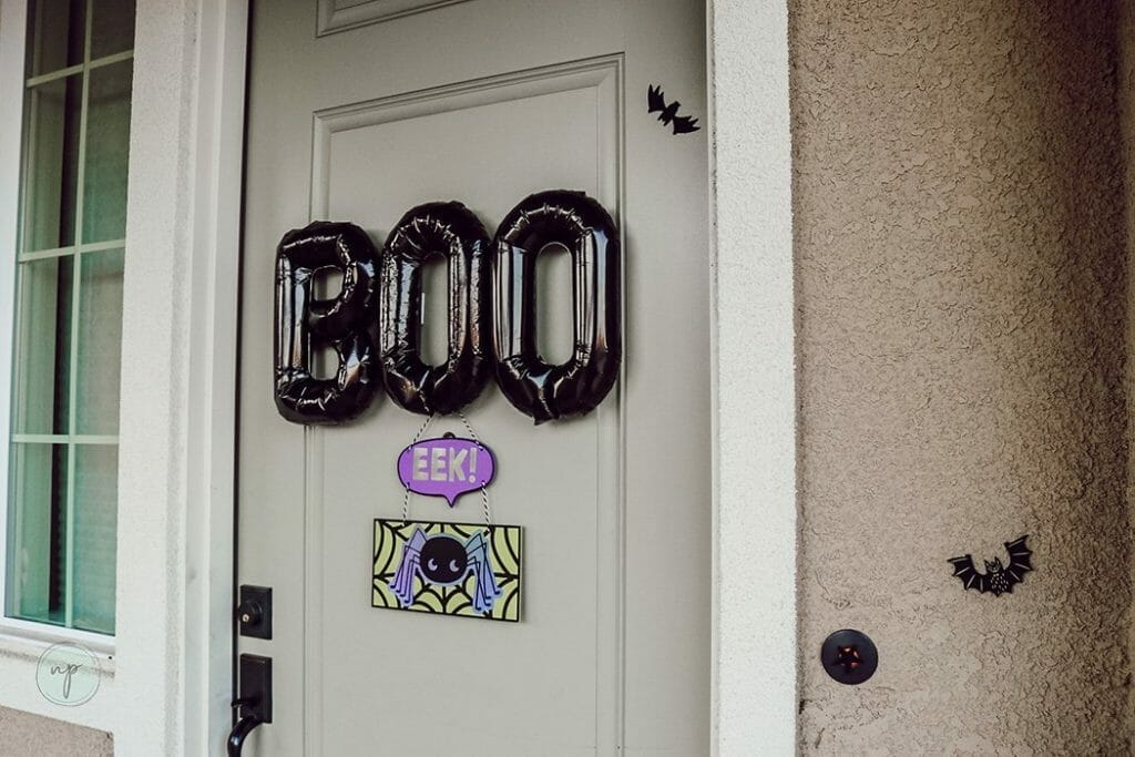 Black Halloween "BOO" balloon on door