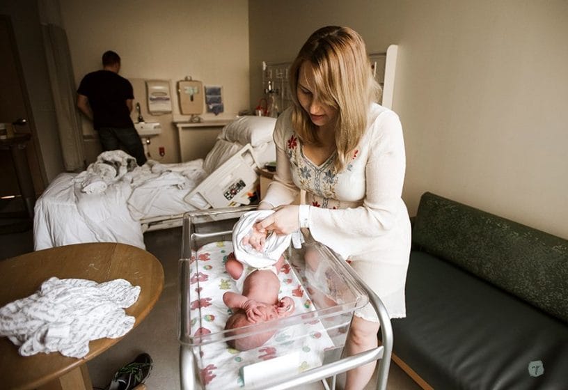 changing baby's clothes after delivery in the hospital