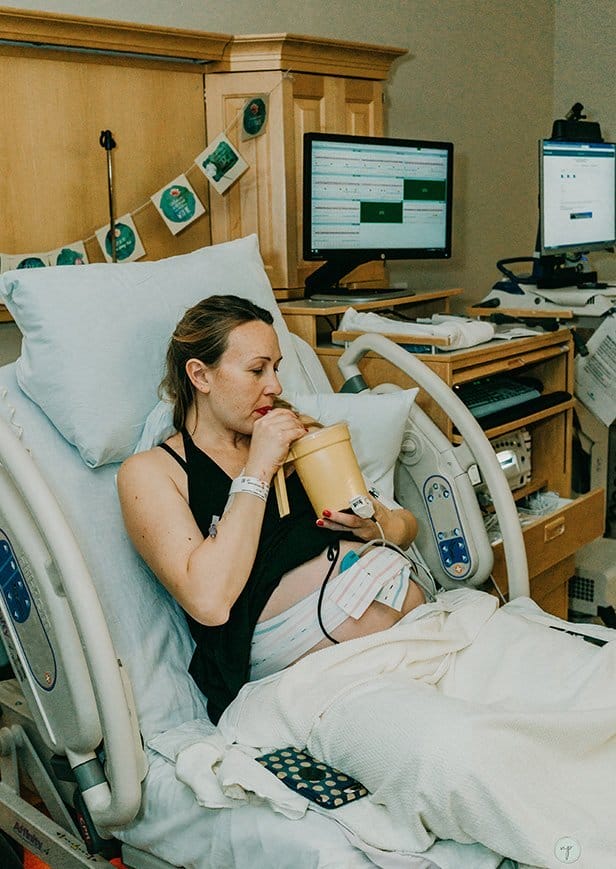 pregnant mom drinking water at the hospital