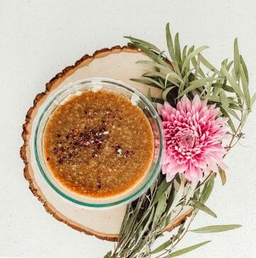 postpartum porridge on a wooden plate with flowers around it