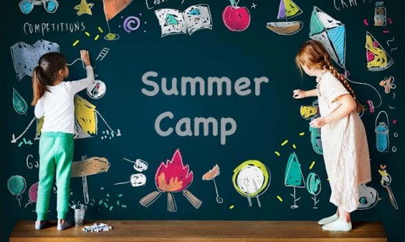 two girls color on a chalkboard that says "summer camp"