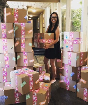 Kim stands with closed summer art boxes