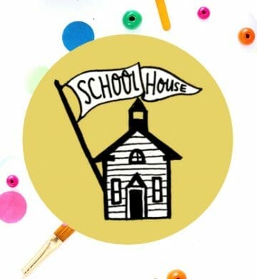 old schoolhouse drawing inside yellow circle with colorful paint dots behind it