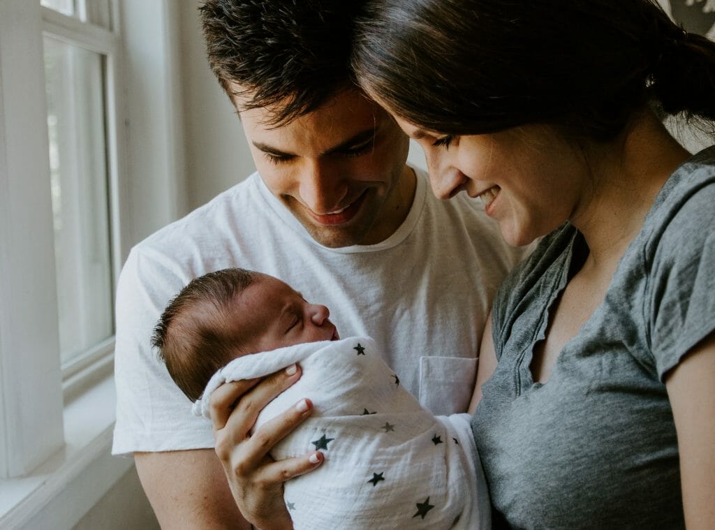 postpartum mo mand dad smile at baby