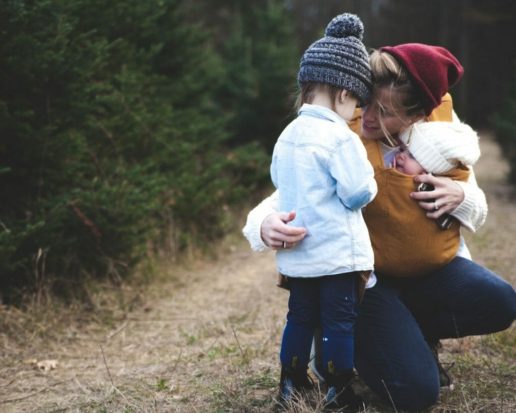 babywearing mom with little kids