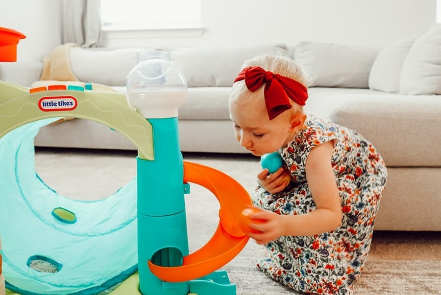 toddler collects balls for Little Tikes activity center