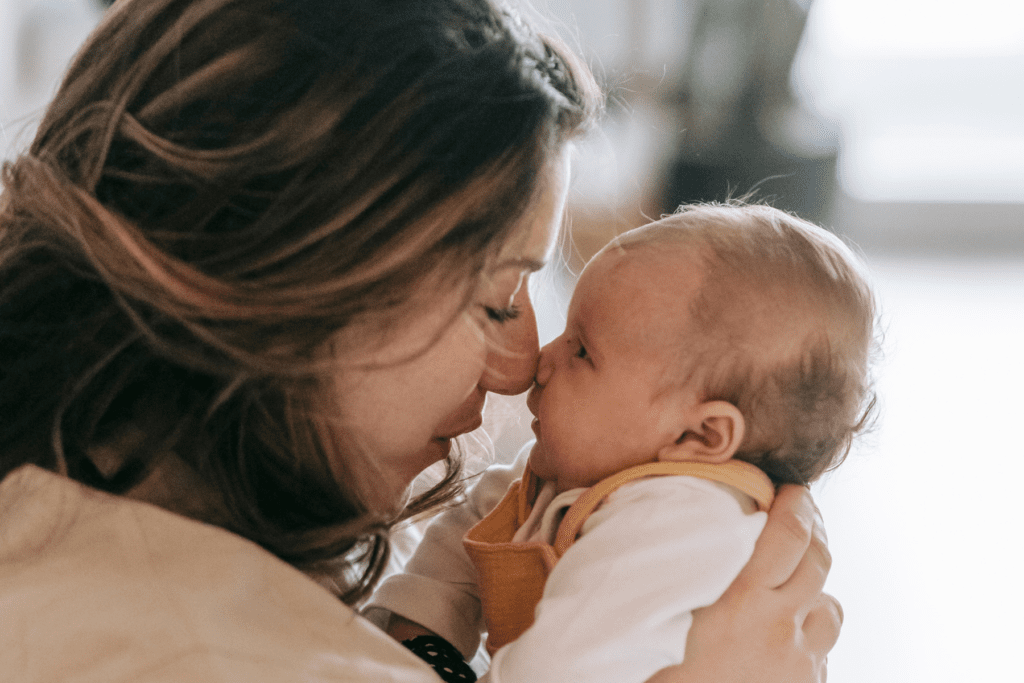 postpartum mom holds baby