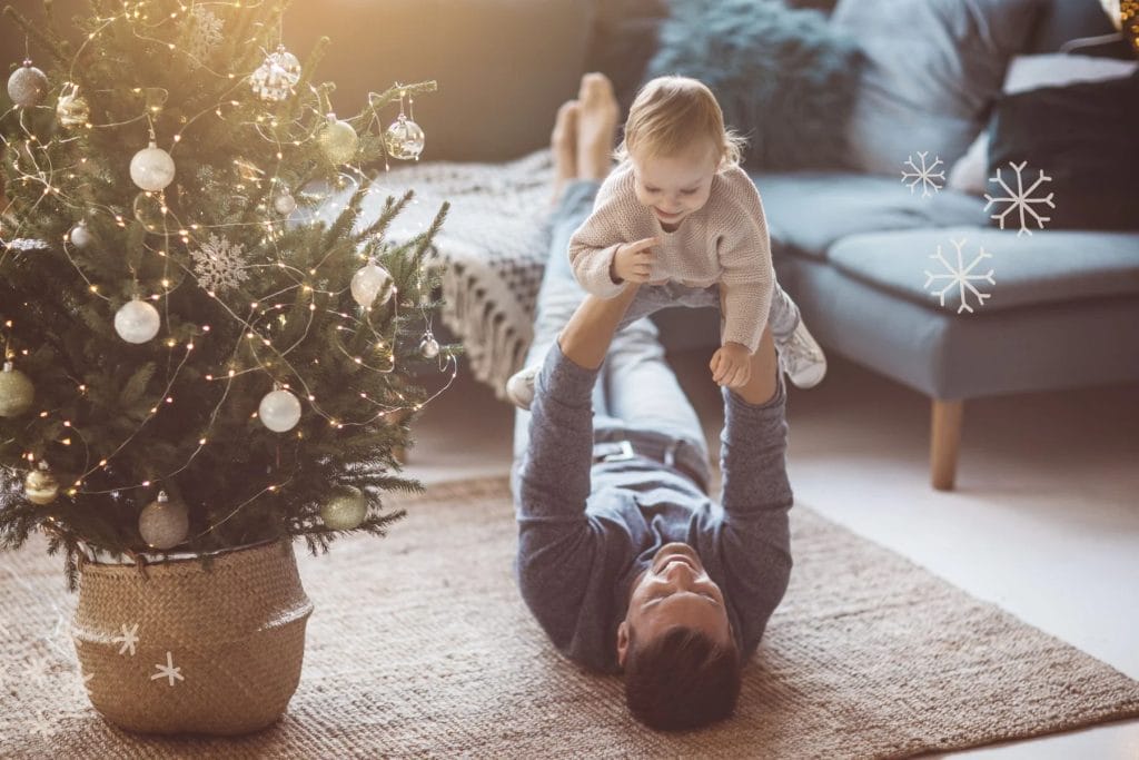 dad and baby by christmas tree
