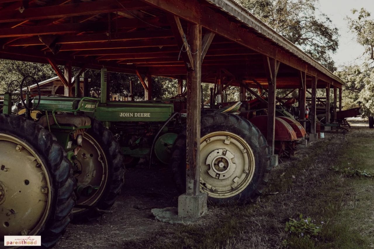 Image of tractors lined up under a shelter