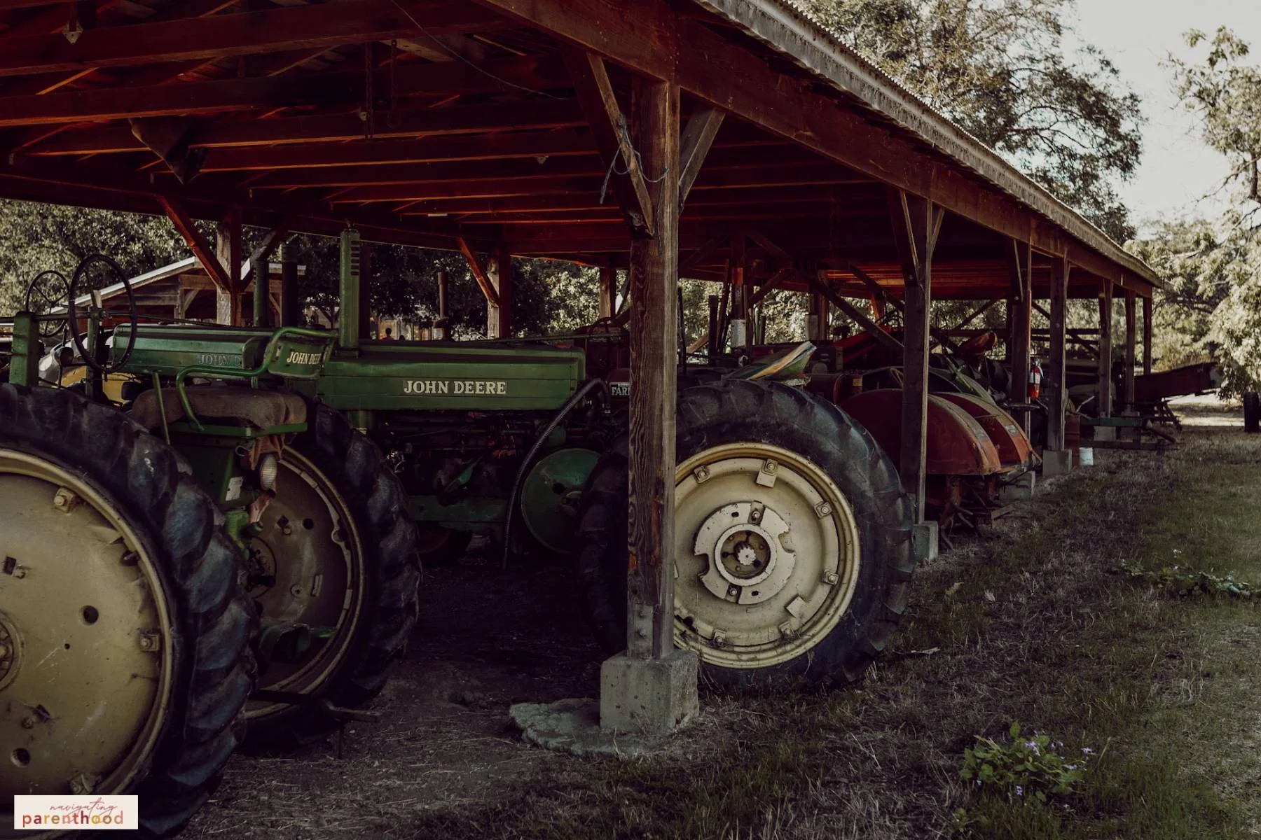 Image of tractors lined up under a shelter