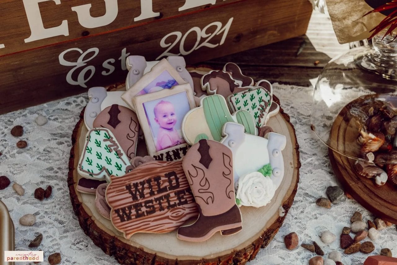 Wild West themed first birthday cookies on a wooden platter
