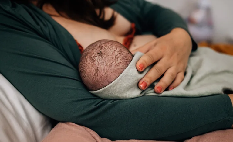 holding newborn baby