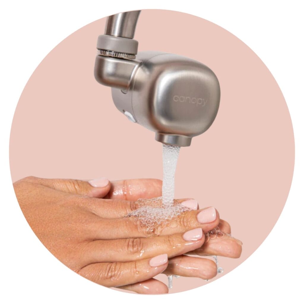 Canopy sink filter with water coming out and person washing hands